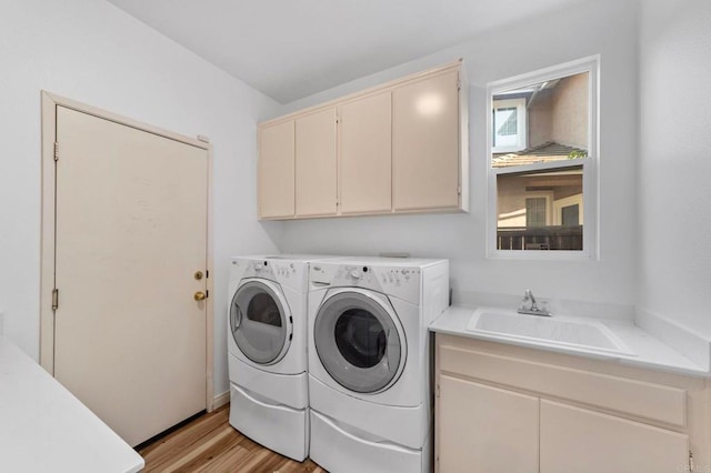 13756 Fontanelle Pl, San Diego, CA 92128 - laundry room featuring washing machine and clothes dryer, cabinet space, and light wood-style flooring