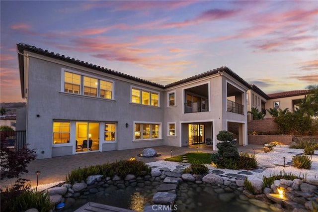 19818 Cornell Ln, Yorba Linda, CA 92886 - back of house featuring a patio, stucco siding, a balcony, an attached garage, and concrete driveway