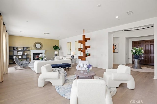 19818 Cornell Ln, Yorba Linda, CA 92886 - living room with light wood-style floors, recessed lighting, and a glass covered fireplace