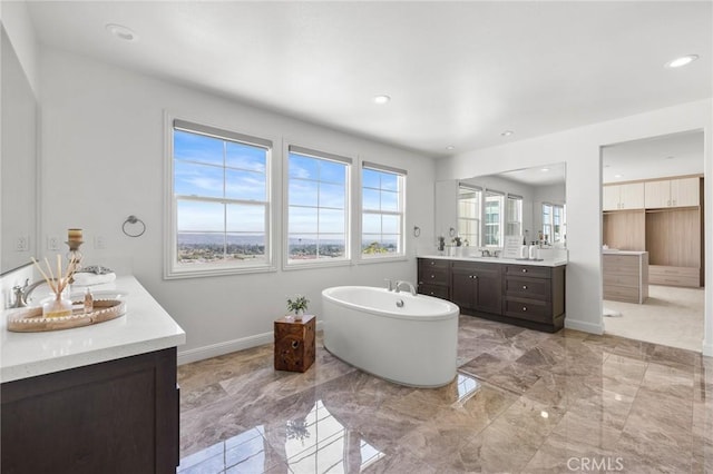19818 Cornell Ln, Yorba Linda, CA 92886 - bathroom with two vanities, a freestanding tub, marble tiled flooring, and recessed lighting