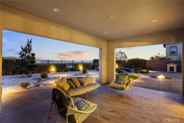 19818 Cornell Ln, Yorba Linda, CA 92886 - patio terrace at dusk featuring a patio, an outdoor living space with a fire pit, and a fenced backyard