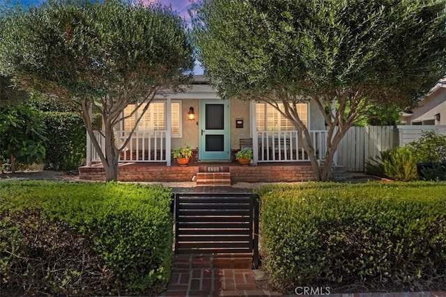 3751 Laurita Ave, Pasadena, CA 91107 - view of property hidden behind natural elements featuring a porch and stucco siding