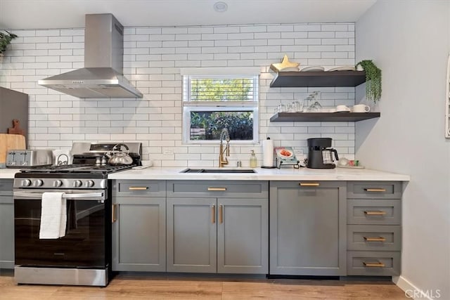 3751 Laurita Ave, Pasadena, CA 91107 - kitchen with gas stove, wall chimney exhaust hood, gray cabinetry, and decorative backsplash