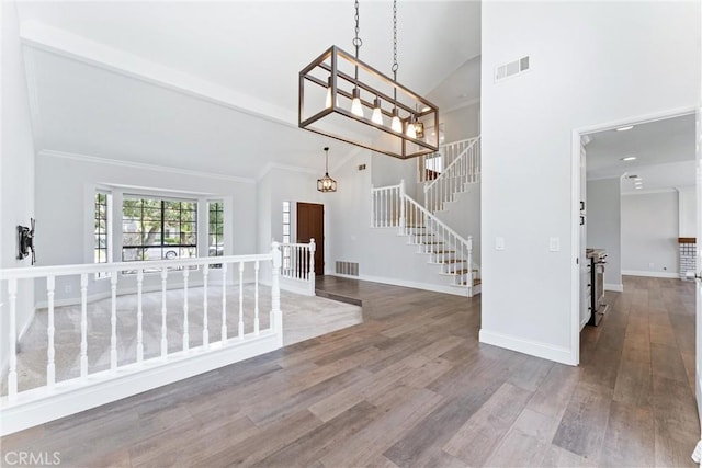 28422 La Pradera, Laguna Niguel, CA 92677 - foyer featuring high vaulted ceiling, wood finished floors, stairway, a chandelier, and ornamental molding