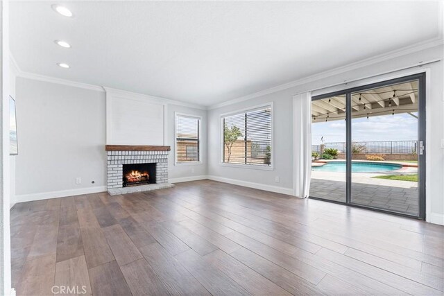 28422 La Pradera, Laguna Niguel, CA 92677 - unfurnished living room with wood finished floors, ornamental molding, a fireplace, and recessed lighting
