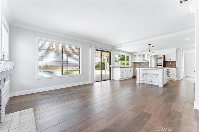 28422 La Pradera, Laguna Niguel, CA 92677 - unfurnished living room with wood finished floors, crown molding, recessed lighting, and a brick fireplace