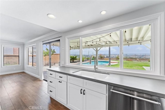 28422 La Pradera, Laguna Niguel, CA 92677 - kitchen featuring stainless steel dishwasher, dark wood-style floors, white cabinets, crown molding, and recessed lighting