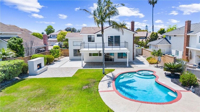 28422 La Pradera, Laguna Niguel, CA 92677 - back of property featuring a lit fireplace, a balcony, a patio area, a fenced backyard, and a residential view