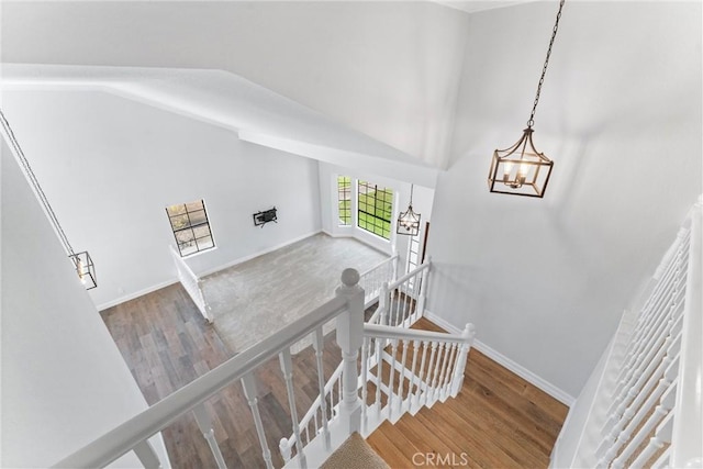 28422 La Pradera, Laguna Niguel, CA 92677 - stairway featuring wood finished floors, vaulted ceiling, and a chandelier