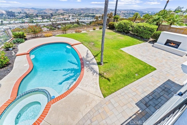 28422 La Pradera, Laguna Niguel, CA 92677 - view of swimming pool with a warm lit fireplace, a patio area, a fenced backyard, a pool with connected hot tub, and a mountain view