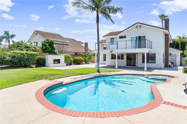 28422 La Pradera, Laguna Niguel, CA 92677 - view of swimming pool with a warm lit fireplace, a patio area, a lawn, and a pool with connected hot tub