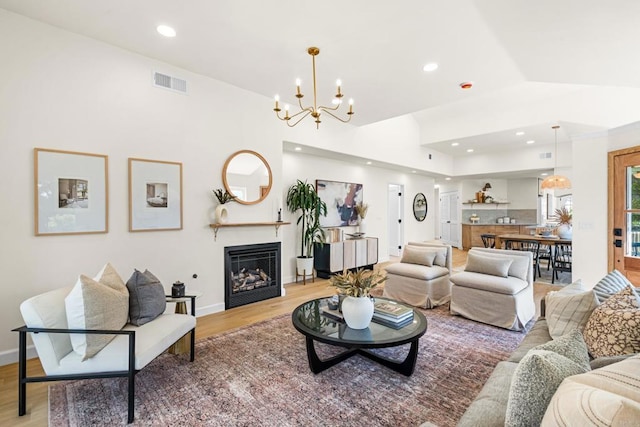 1481 Camino Linda Dr, San Marcos, CA 92078 - living room with a chandelier, light wood finished floors, recessed lighting, a fireplace, and vaulted ceiling
