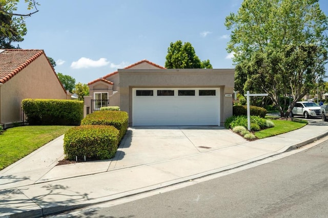 1481 Camino Linda Dr, San Marcos, CA 92078 - mediterranean / spanish-style house with an attached garage, stucco siding, a tile roof, and concrete driveway