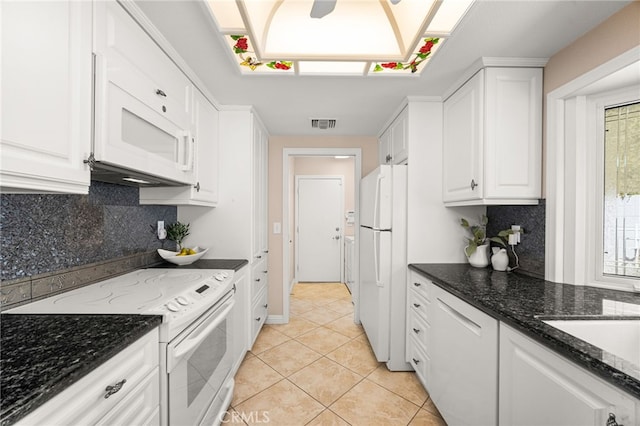 651 Lemke Dr, Placentia, CA 92870 - kitchen with white appliances, white cabinets, tasteful backsplash, light tile patterned floors, and dark stone counters