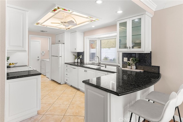 651 Lemke Dr, Placentia, CA 92870 - kitchen featuring washing machine and dryer, a peninsula, white cabinetry, white appliances, and recessed lighting