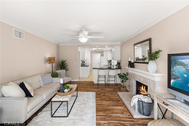 651 Lemke Dr, Placentia, CA 92870 - living area featuring ceiling fan, wood finished floors, crown molding, and a premium fireplace