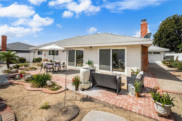 651 Lemke Dr, Placentia, CA 92870 - back of house with stucco siding, a patio, a chimney, and an outdoor hangout area