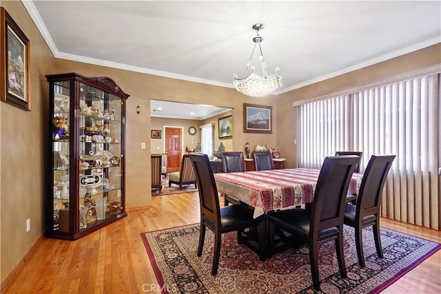 56665672 Franklin Ave, Los Angeles, CA 90028 - dining area with a chandelier, light wood-style floors, and crown molding