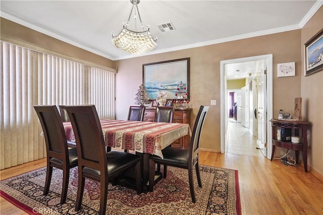 56665672 Franklin Ave, Los Angeles, CA 90028 - dining area featuring a chandelier, light wood-style floors, and ornamental molding