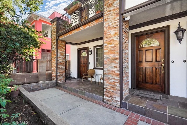 56665672 Franklin Ave, Los Angeles, CA 90028 - view of exterior entry featuring a porch and a surveillance system