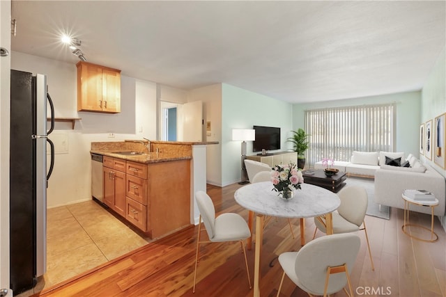 5585 E Pacific Coast Unit 144, Long Beach, CA 90804 - dining space with light wood-style floors and baseboards