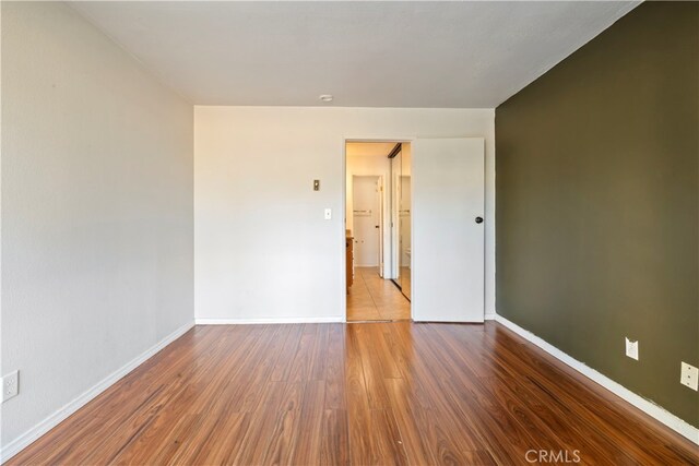 5585 E Pacific Coast Unit 144, Long Beach, CA 90804 - spare room featuring wood finished floors and baseboards