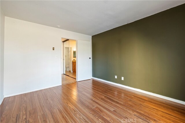 5585 E Pacific Coast Unit 144, Long Beach, CA 90804 - spare room with wood finished floors and baseboards