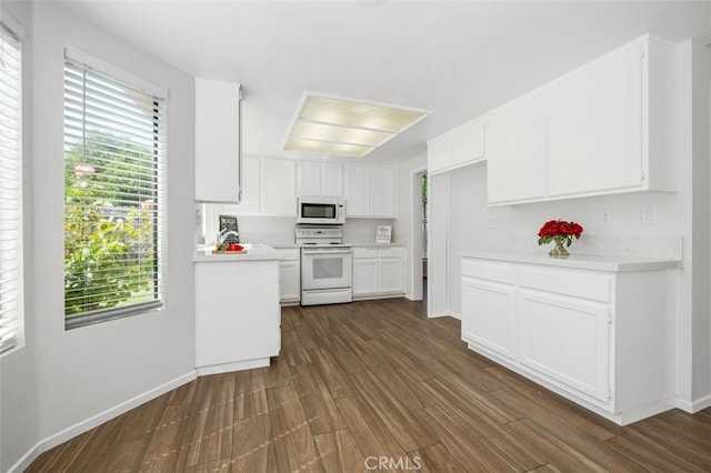 28611 Avenida Del Caballo, Laguna Niguel, CA 92677 - kitchen featuring white appliances, dark wood-style floors, light countertops, and plenty of natural light