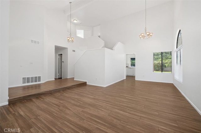 28611 Avenida Del Caballo, Laguna Niguel, CA 92677 - unfurnished living room featuring a chandelier, a towering ceiling, and wood finished floors