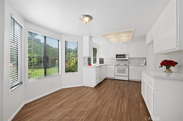 28611 Avenida Del Caballo, Laguna Niguel, CA 92677 - kitchen with white appliances, light countertops, dark wood-style floors, and white cabinets