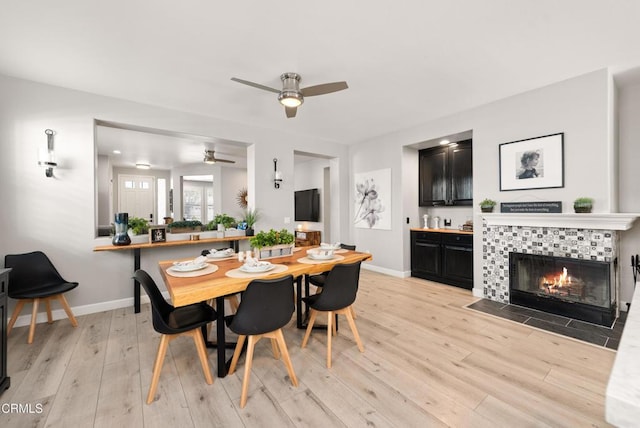 5091 Via Fresco, Camarillo, CA 93012 - dining room with a ceiling fan, light wood-style flooring, and a tiled fireplace