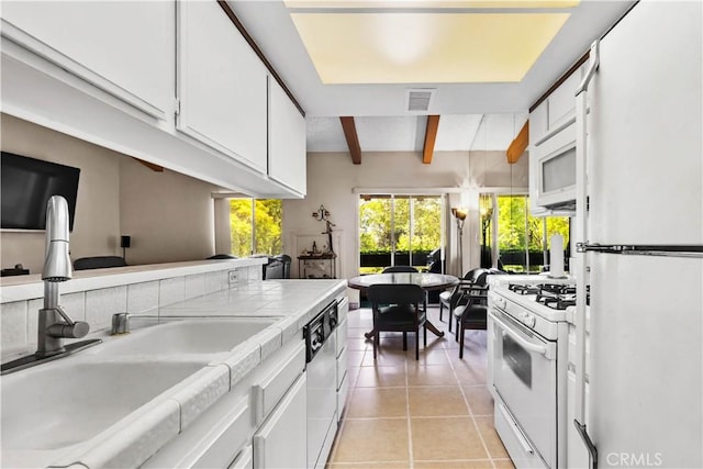 2700 Cahuenga Blvd E Unit 1302, Los Angeles, CA 90068 - kitchen with white appliances, white cabinetry, light tile patterned floors, and tile counters