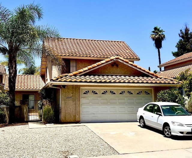 2339 Conway Dr, Escondido, CA 92026 - view of front facade featuring concrete driveway, an attached garage, a tile roof, a gate, and stucco siding