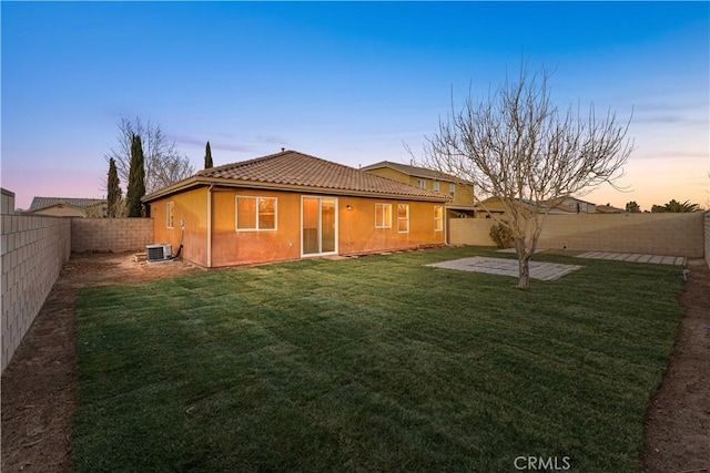 3150 James Ct, Lancaster, CA 93535 - back of property with a tiled roof, a fenced backyard, stucco siding, and a patio area