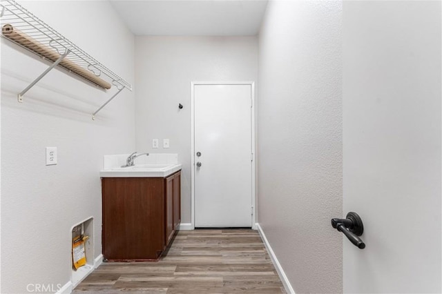 3150 James Ct, Lancaster, CA 93535 - laundry room with light wood-type flooring and a sink