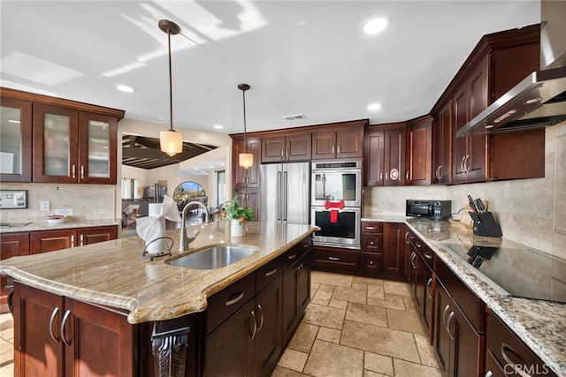 38225 Camino Sierra Rd, Temecula, CA 92592 - kitchen featuring wall chimney range hood, appliances with stainless steel finishes, stone tile flooring, tasteful backsplash, and recessed lighting