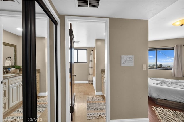 38225 Camino Sierra Rd, Temecula, CA 92592 - corridor featuring baseboards and light wood-type flooring
