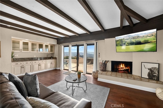 38225 Camino Sierra Rd, Temecula, CA 92592 - living area featuring beamed ceiling, a lit fireplace, and dark wood finished floors