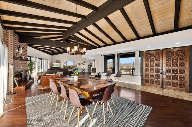 38225 Camino Sierra Rd, Temecula, CA 92592 - dining room with a fireplace, a chandelier, a wooden ceiling with exposed beams, hardwood / wood-style flooring, and healthy amount of natural light