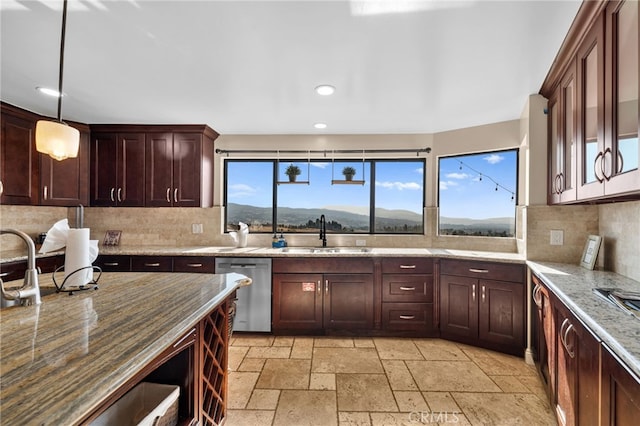 38225 Camino Sierra Rd, Temecula, CA 92592 - kitchen with stainless steel dishwasher, stone tile flooring, recessed lighting, light stone countertops, and backsplash