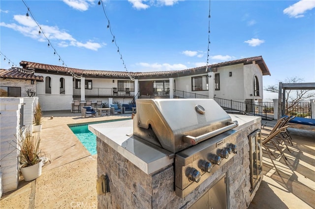 38225 Camino Sierra Rd, Temecula, CA 92592 - rear view of house with an outdoor kitchen, an outdoor pool, a patio, and stucco siding