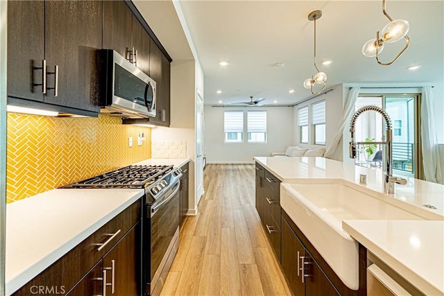 275 Pin Ln, Covina, CA 91722 - kitchen featuring appliances with stainless steel finishes, light wood-type flooring, light countertops, recessed lighting, and pendant lighting