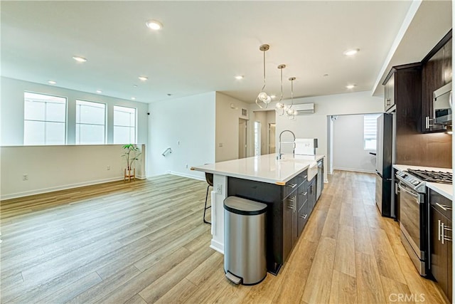 275 Pin Ln, Covina, CA 91722 - kitchen featuring stainless steel appliances, light wood-type flooring, a kitchen island with sink, light countertops, and recessed lighting