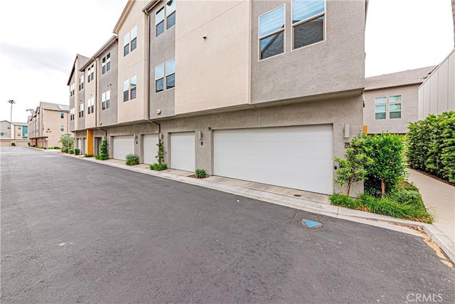 275 Pin Ln, Covina, CA 91722 - view of building exterior with an attached garage and a residential view