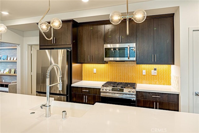 275 Pin Ln, Covina, CA 91722 - kitchen featuring appliances with stainless steel finishes, light countertops, dark brown cabinetry, and backsplash