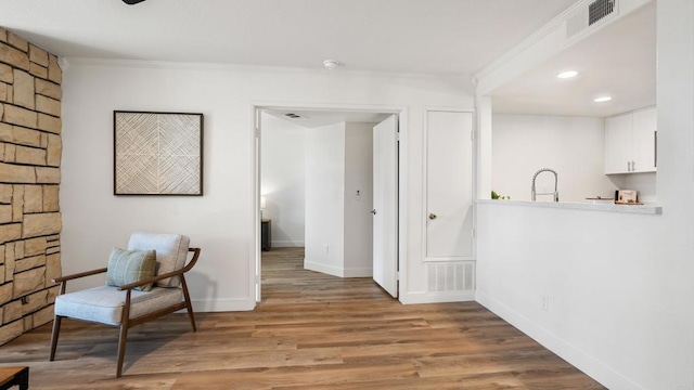 415 Stoney Point Way Unit 106, Oceanside, CA 92058 - living area featuring wood finished floors, ornamental molding, and recessed lighting