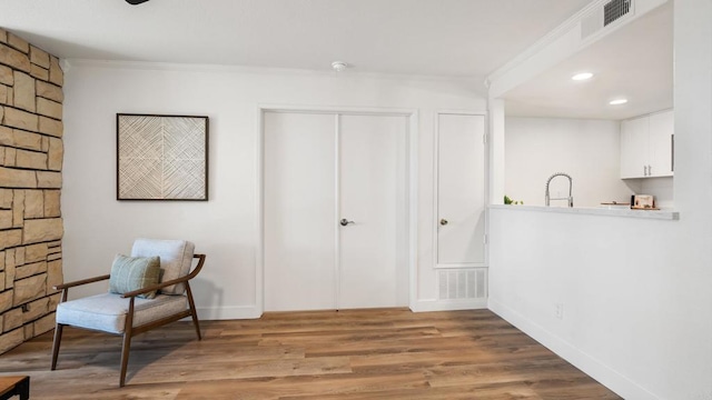 415 Stoney Point Way Unit 106, Oceanside, CA 92058 - living area with wood finished floors, ornamental molding, and recessed lighting
