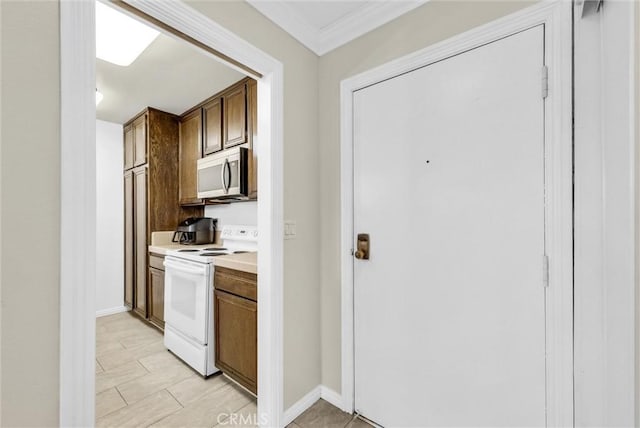4170 Elm Ave Unit 304, Long Beach, CA 90807 - kitchen with electric stove, stainless steel microwave, light countertops, crown molding, and light tile patterned floors