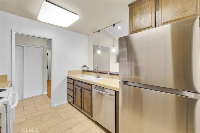 4170 Elm Ave Unit 304, Long Beach, CA 90807 - kitchen with stainless steel appliances, light countertops, and pendant lighting