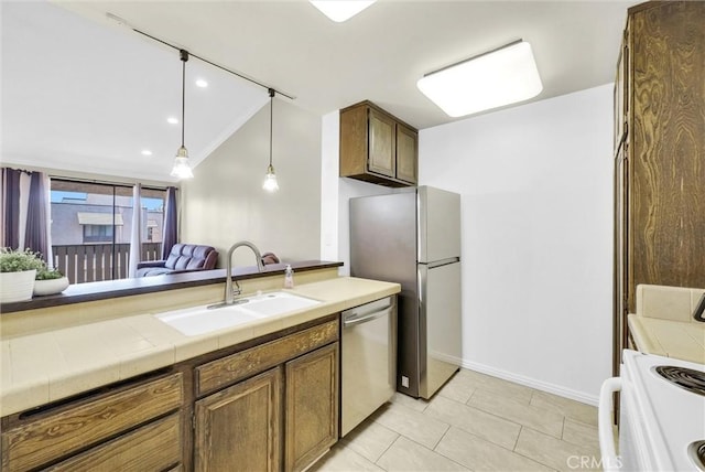 4170 Elm Ave Unit 304, Long Beach, CA 90807 - kitchen with stainless steel dishwasher, range, freestanding refrigerator, vaulted ceiling, and light tile patterned floors
